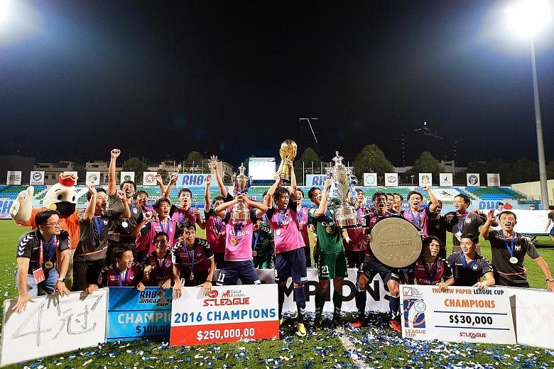 Above: Albirex Niigata with the four pieces of silverware they won this season - the Charity Shield, League Cup, S-League trophy and Singapore Cup. Left: Tampines star Jermaine Pennant in action after coming off the bench in the 68th minute, with his