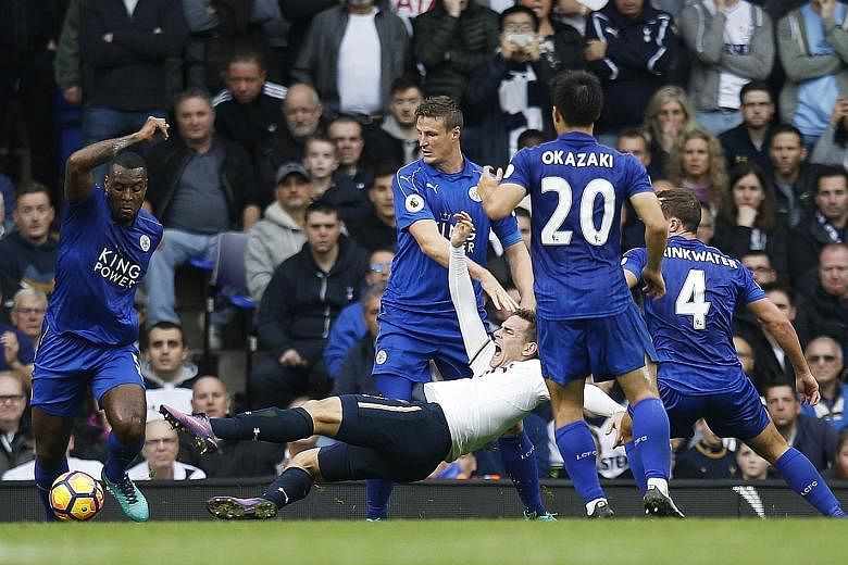 Tottenham Hotspur striker Vincent Janssen being pulled down by Leicester City defender Robert Huth in the box just before half-time in their English Premier League clash yesterday. The Dutchman scored the resultant penalty for hosts Spurs, but the de