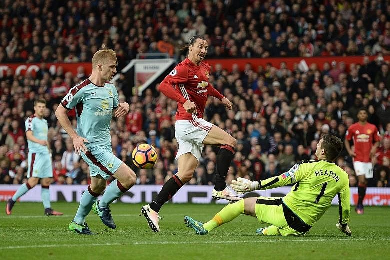 Burnley goalkeeper Tom Heaton saving from Manchester United's Zlatan Ibrahimovic in their match at Old Trafford. Poor finishing and indiscipline are becoming bigger problems for United than injuries.