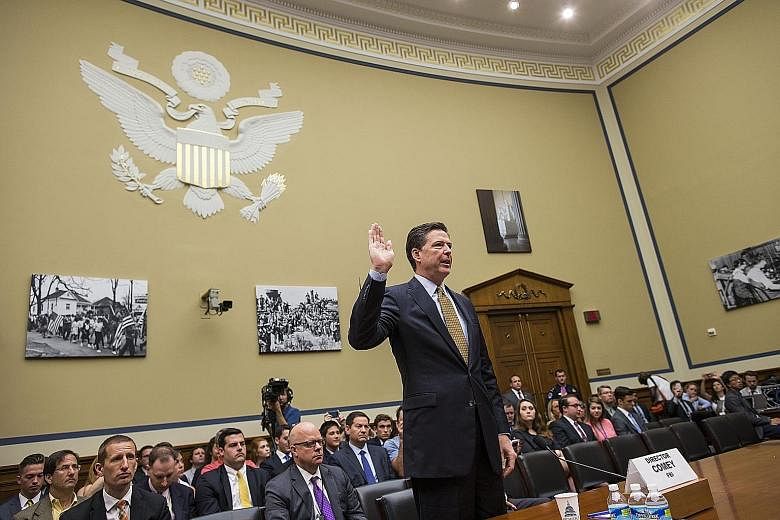 Mr Comey being sworn in to testify on Capitol Hill in Washington on July 7. The FBI director has been accused by Clinton allies of trying to influence the presidential election on Nov 8, by revealing that the FBI was restarting a probe into the forme