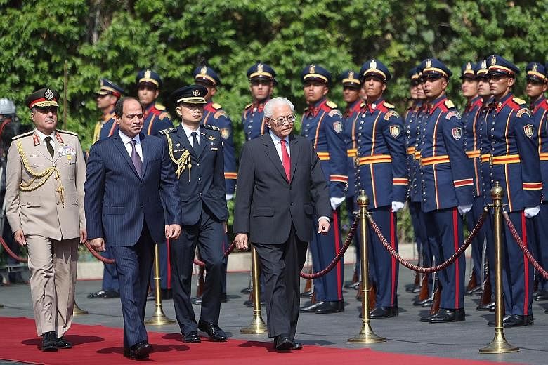 President Tan inspecting the military guard of honour with Egyptian President Sisi at the presidential palace yesterday. Dr Tan, in Egypt on his first state visit, said that both countries have a "close partnership, anchored by shared interests". The