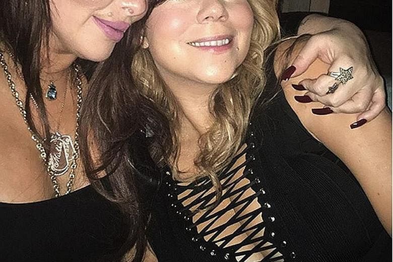 Pop star Mariah Carey (right) with her manager friend Stella Bulochnikov, whom Woman's Day reported caused her alleged split with Australian tycoon James Packer.