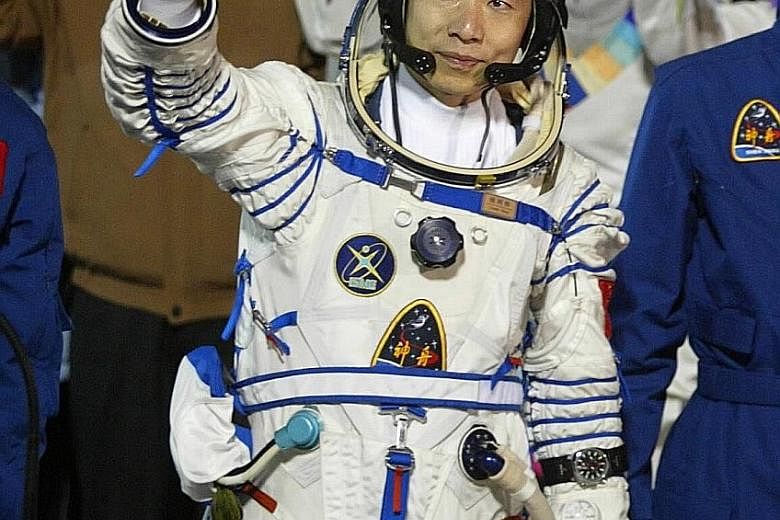 China's first female astronaut Liu (centre) on her return on June 29, 2012. Astronaut Yang was China's first man in space.