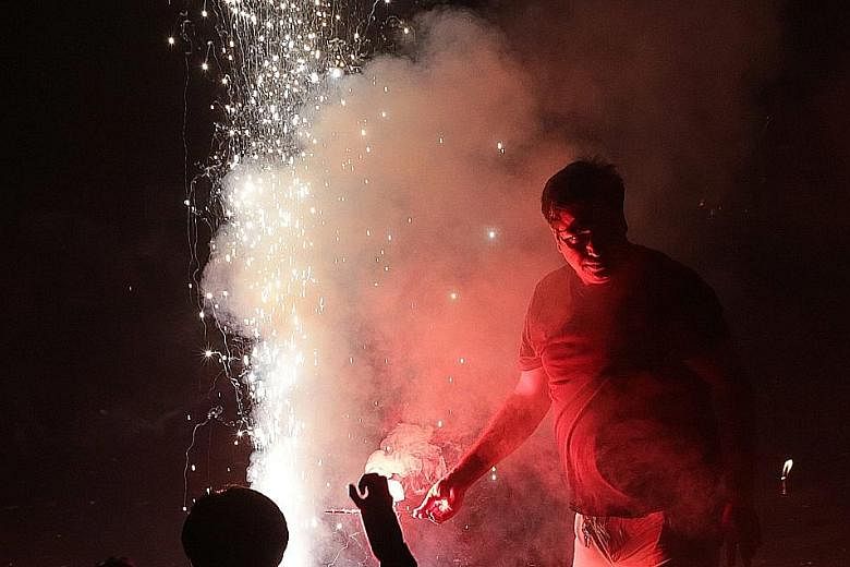Firecrackers being lit during Diwali festivities near New Delhi on Sunday. Pollution levels surge at this time traditionally, but the authorities said it was worse this year due to high levels of moisture in the air and the burning of agricultural re
