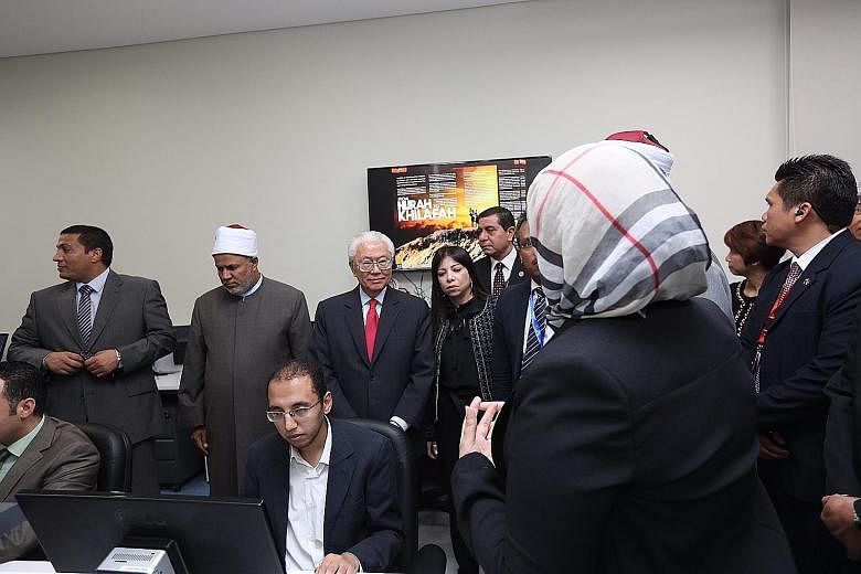 President Tan touring the Al Azhar Observatory for Foreign Languages in eastern Cairo - a key institution in Egypt's battle against religious extremism - on Monday afternoon with Parliamentary Secretary for Trade and Industry Low Yen Ling (second fro