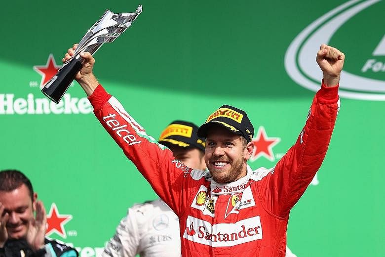 Sebastian Vettel with his trophy after being promoted to third place at the Mexican Grand Prix. But his joy was short-lived as he was demoted to fifth when dealt a 10-second penalty. The German also had a go at FIA race director Charlie Whiting as te