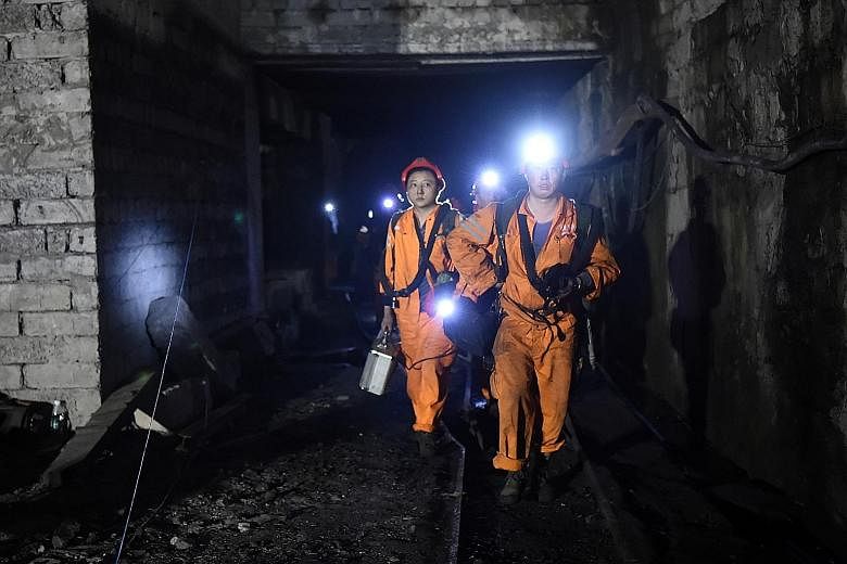 Rescuers exiting the mine in Chongqing on Monday. More than 400 rescuers were digging through the underground passageways, some of which had been blocked by ruins from collapsed tunnels.