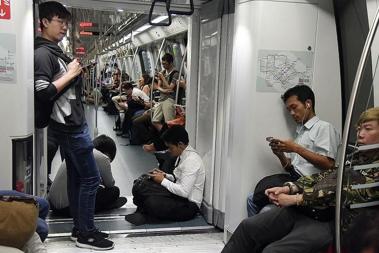 Passengers waiting inside a stationary train at Marymount MRT station yesterday. SMRT said preliminary findings revealed a communications glitch similar to the one which disrupted service on the Circle Line for a week in August.