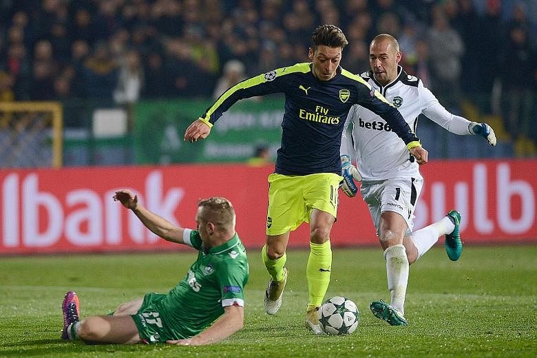 Arsenal's Mesut Ozil outfoxing the Ludogorets defence before scoring an 88th-minute winner in the Champions League clash. The German dinked the ball over 'keeper Milan Borjan, and left two defenders on their backsides before passing the ball into the