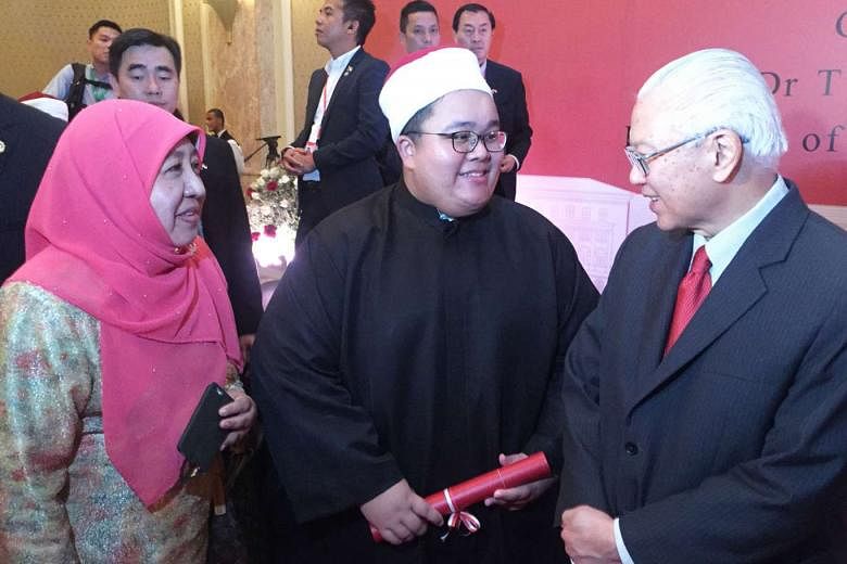 Mr Aufa and his mother, Madam Saudah Haji Shafii, chatting with Dr Tan at a reception for Singaporean graduates at the Four Seasons Hotel in Cairo, on Tuesday. Dr Tan congratulated the graduates, saying they were "the next generation of leaders for the Mu