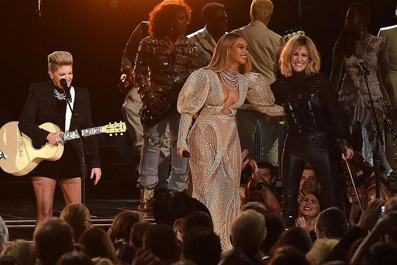 Beyonce (above left) performing with Martie Maguire of Dixie Chicks.