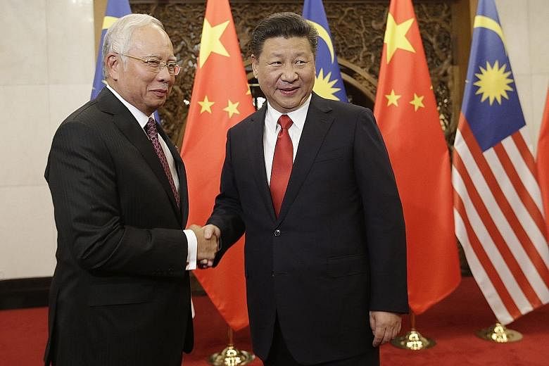 Mr Najib with Mr Xi at Beijing's Diaoyutai State Guesthouse yesterday. The Malaysian Prime Minister, on his third visit to China since being elected in 2009, said that both countries are "good neighbours and friends that could be trusted".