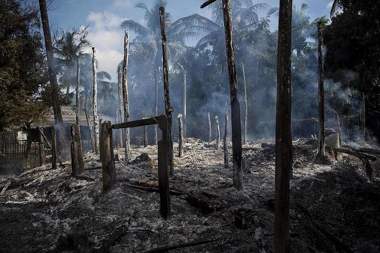 Burnt-out houses in Warpait, a Muslim village in Rakhine state, following conflict in the area. Ms Suu Kyi has faced criticism over her government's handling of the crisis.