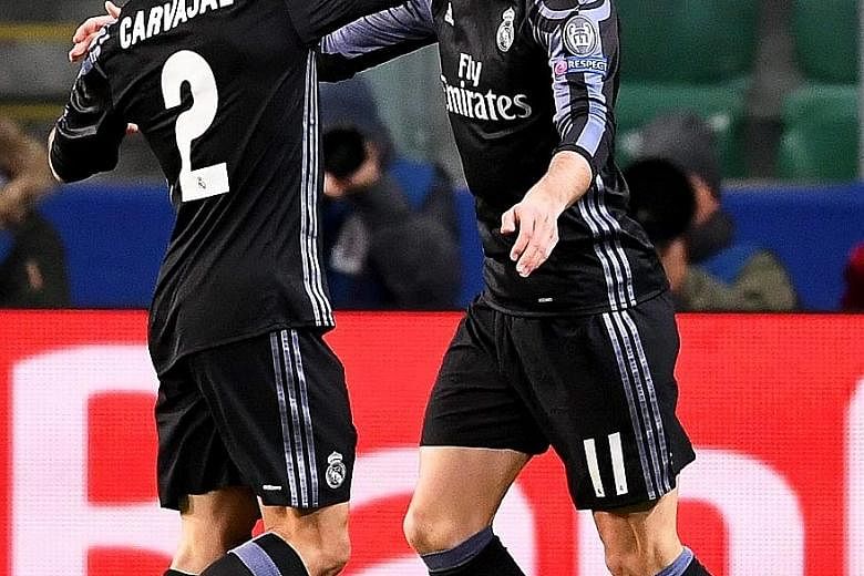 Gareth Bale celebrating with team-mate Dani Carvajal after his quick opener. But Legia Warsaw battled back with three goals and only a late equaliser helped Real save a point.
