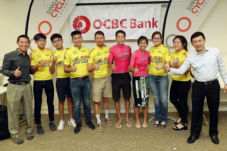 Cycling federation head Jeffrey Goh (right) and honorary general secretary Hing Siong Chen (left) with the winners of the OCBC Cycle Road Series yesterday. They are (second from left onwards): Moh Jie Yu (Junior B), Firoz Loh (Junior A), Lance Tan (m