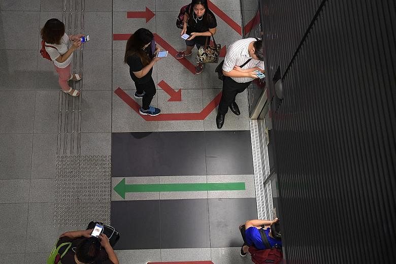 Circle Line users at Buona Vista MRT station yesterday. A signal interference first disrupted services on the Circle Line for a week in late August, resulting in slower train speeds and reduced service frequency. It resurfaced on Wednesday after a re