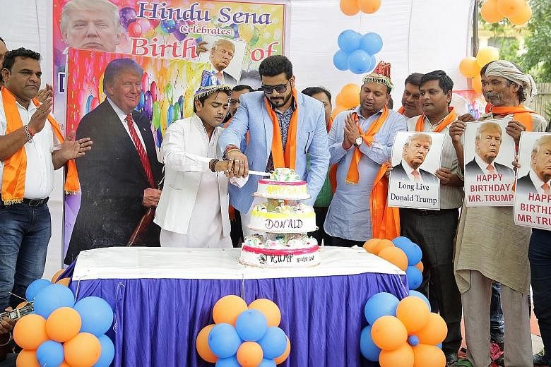 Activists from the right-wing organisation Hindu Sena celebrating US presidential candidate Donald Trump's 70th birthday in New Delhi, India, in June. Even though Mr Trump has struck a chord with such nationalist groups with his promises to fight Isl