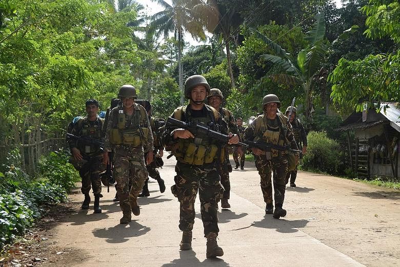 Patrolling Philippine soldiers return to camp in Patikul town, Sulu province, on the southern island of Mindanao. The strife-torn south of the Philippines is home to various militant groups