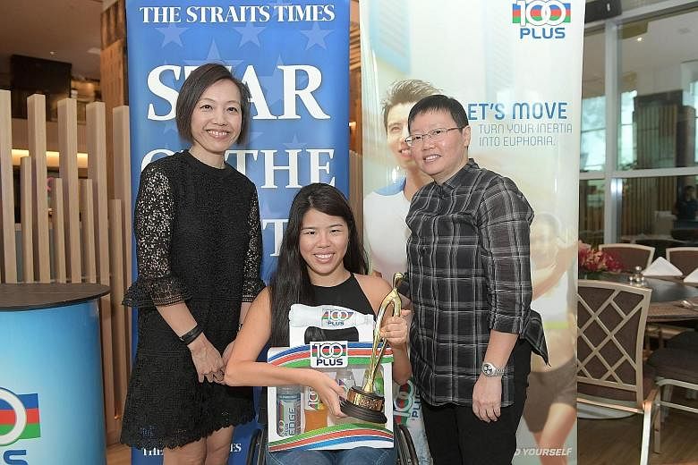 Yip Pin Xiu, The Straits Times' Star of the Month for September, receiving her award at Pan Pacific Orchard. The 24-year-old is flanked by Jennifer See, general manager of F&N Foods Singapore, and ST sports editor Lee Yulin (far right). Yip was recog