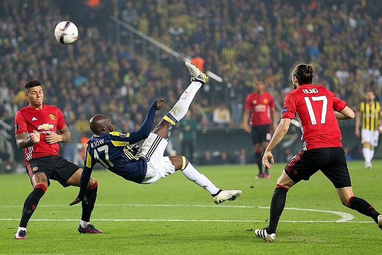 Moussa Sow's superb bicycle kick gives Fenerbahce a 1-0 lead as United's Marcos Rojo and Daley Blind fail to stop him.