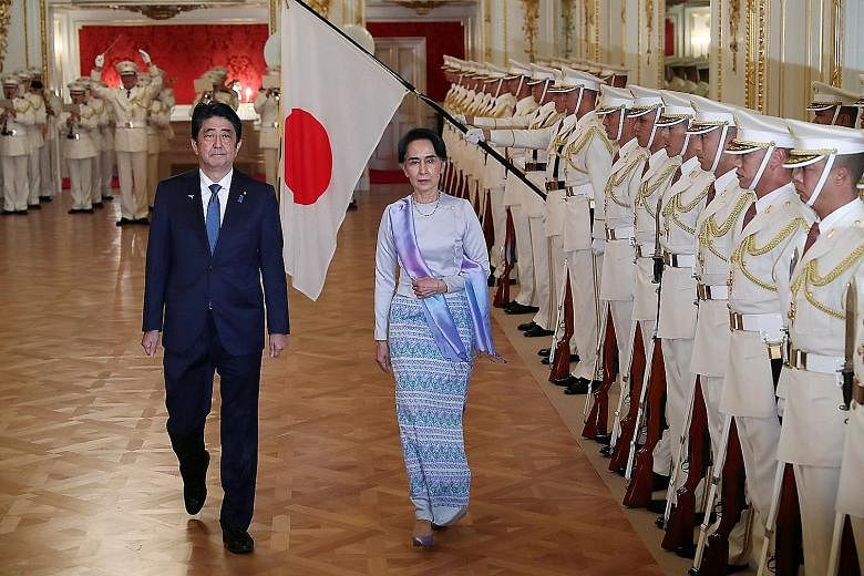 Japanese Prime Minister Shinzo Abe with Myanmar State Counsellor Aung San Suu Kyi in Tokyo on Wednesday. Mr Abe has pledged $10.7 billion in aid, loans and investments in Myanmar over five years.
