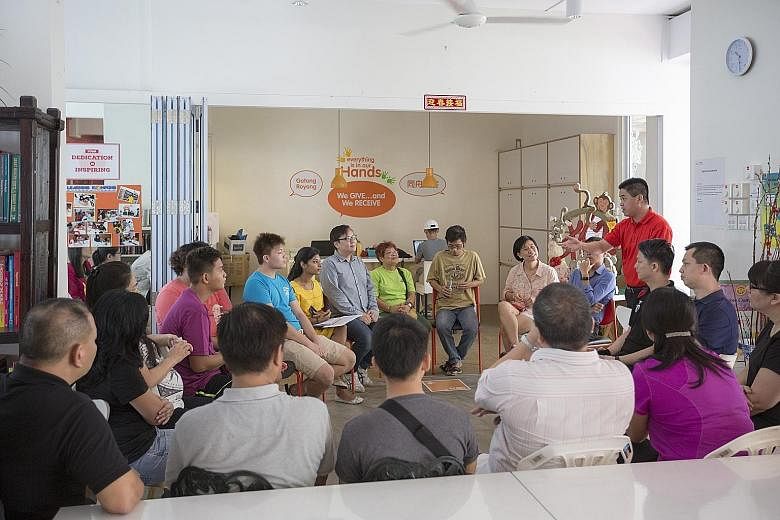 Mr Benny Ng (in red), general manager of operations at ABR Holdings' Swensen's, speaking to representatives of ABR and South Central Community Family Service Centre. The family service centre's staff learnt about safety at work and food handling prac