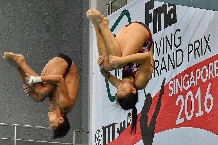 Above: Singapore's Joshua Chong and Ashlee Tan in action at the Fina Diving Grand Prix at the OCBC Aquatic Centre yesterday. The duo posted a score of 243.78 in the mixed synchronised 3m event, meeting the Singapore Swimming Association's qualifying 