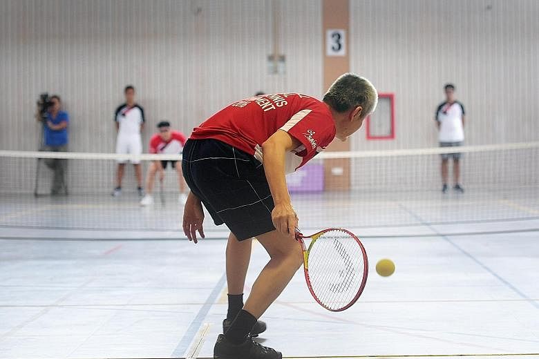 Hung Kee Seng about to return to Ong Hock Bee in the B1 final of the first National Soundball Tournament yesterday. Ong won 4-0. Players locate the ball by the rattling sound it makes.