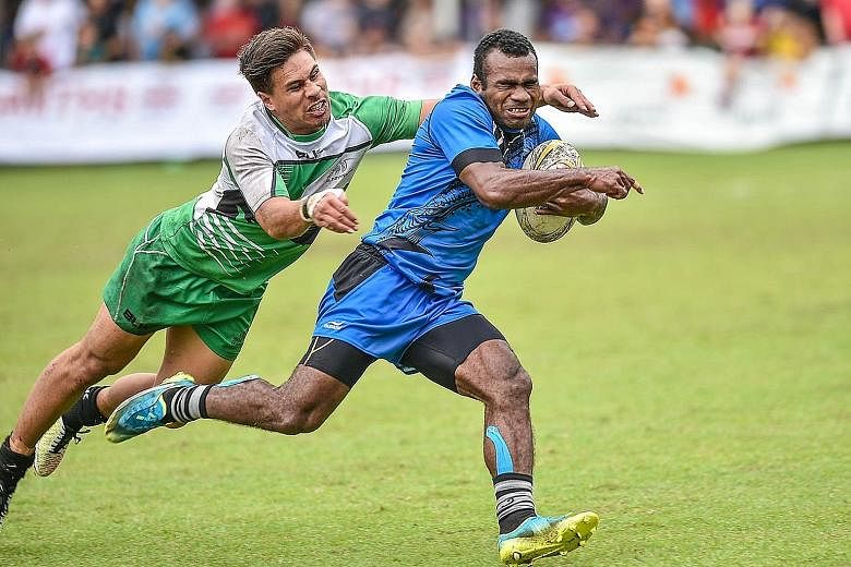 Jerry Tuwai (right) during Daveta's 12-29 defeat by Sunnybank of Australia in their final pool match of the SCC 7s at the Padang yesterday. The Fijian side went on to lose 5-7 to England Academy in the quarter-finals.