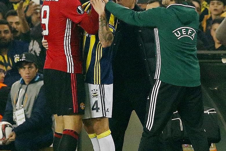 Zlatan Ibrahimovic grabs the throat of Fenerbahce's Simon Kjaer during a bust-up in their Europa League game that the Turkish side won 2-1. Manager Jose Mourinho has no issue with the Swede's contribution except in Thursday's match.