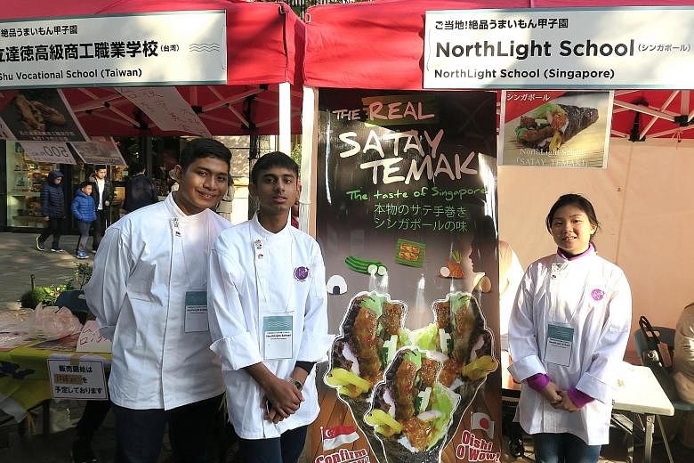 Northlight School students (from left) Firdaus, Amshyar and Li Lin at their booth in Tokyo yesterday. Their satay temaki dish is made by wrapping lettuce, egg, cucumber, onion, rice and satay chicken in seaweed and then dousing it in a piquant satay 