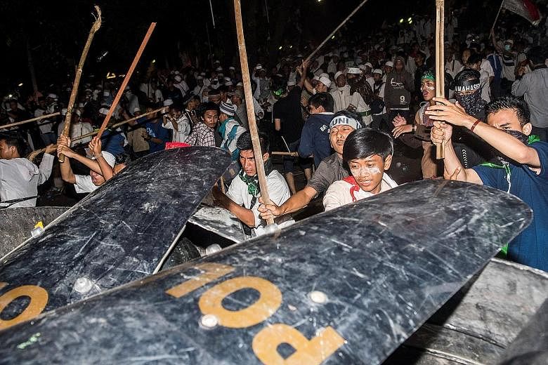 Muslim hard-line protesters clashing with anti-riot policemen during last Friday's protest against Jakarta Governor Basuki Tjahaja Purnama, a Chinese Christian, who is accused of insulting Islam.