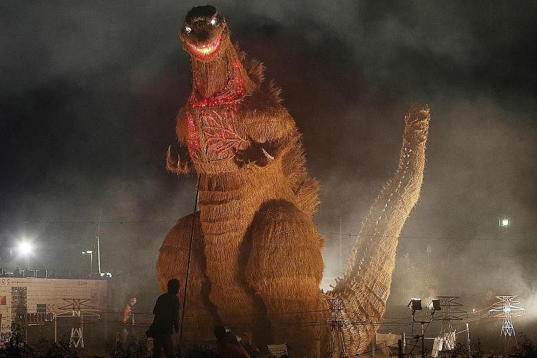 A 7m-tall Godzilla figure - made from wood and bamboo and covered with straw - on display at the autumn festival in Chikuzen in Japan's Fukuoka prefecture on Saturday. It was created by about 210 volunteers.