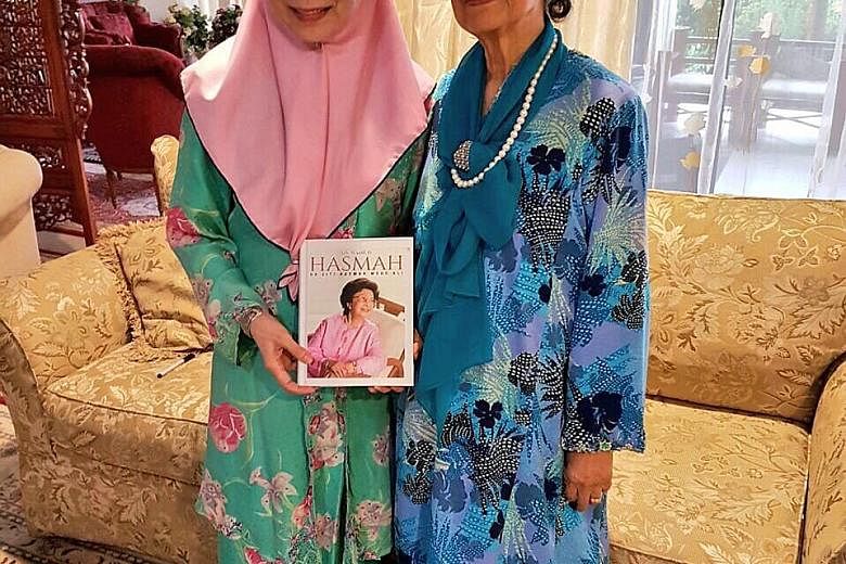 Tun Dr Mahathir's wife, Tun Siti Hasmah Mohamad Ali (right), with Anwar Ibrahim's wife, Dr Wan Azizah Wan Ismail, at the latter's home. She gave Dr Wan Azizah a copy of her biography, My Name Is Hasmah.