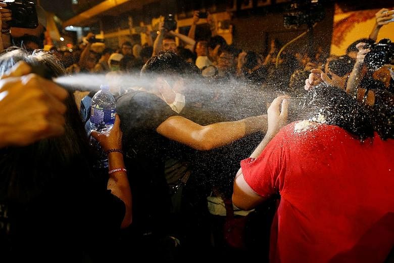 Police using pepper spray to disperse protesters during yesterday's protest in Hong Kong. As of 10pm, at least four groups of protesters were still in stand-offs with police. Protesters facing off against police in Hong Kong last night, the eve of a 