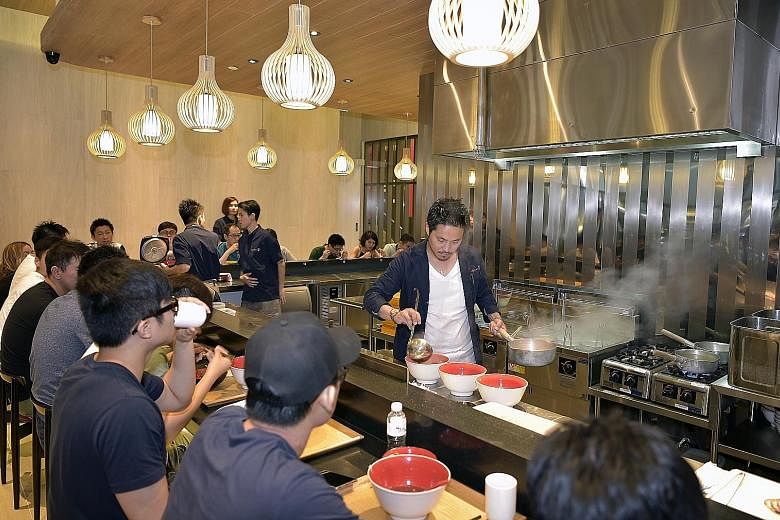Tsuta's chef-owner Yuki Onishi cooking at the outlet at Pacific Plaza.