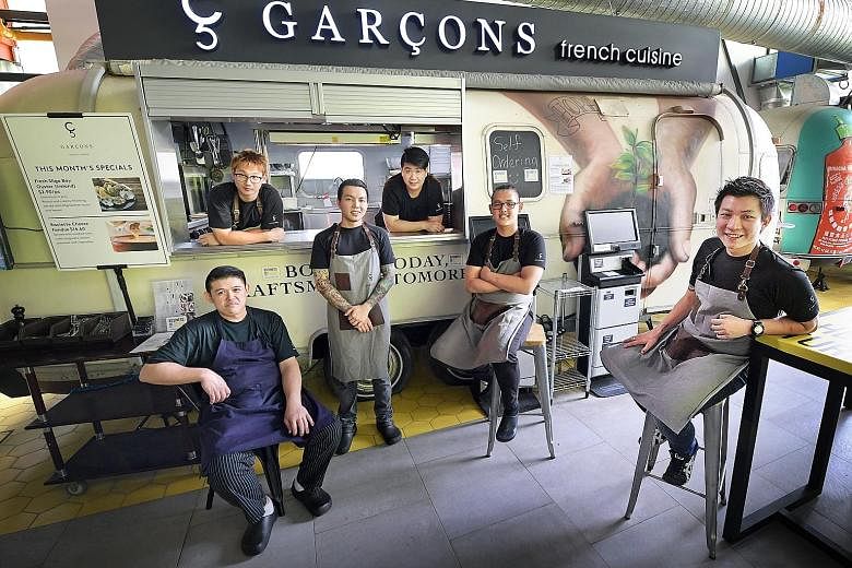 From left: Mr Yip Wing Hoe, 31, Mr Jordan Chuan, 25, Mr Kevan Tan, 24, Mr Voon Chung Kiat, 26, Mr Aiden Lua, 22, and E&I Food Concepts founder Enoch Teo, 26, at the Garcons outlet at Timbre+. E&I Food Concepts is a social enterprise that runs Garcon,