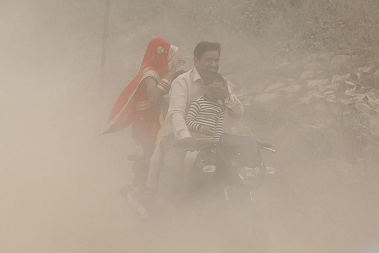 A family riding through the heavy pollution in New Delhi on Sunday, where the poor air has forced a million schoolchildren to stay at home. Mr K. K. Agarwal, president of the Indian Medical Association, has called the current haze blanketing the city