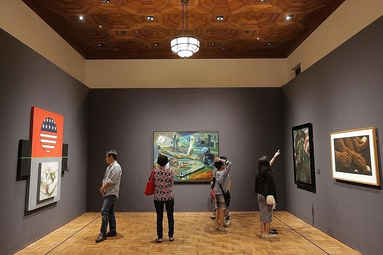 Visitors viewing the artworks at the National Gallery Singapore. More than 60 activities, including a light show on the facade of the museum, will be held as part of its first anniversary celebrations.