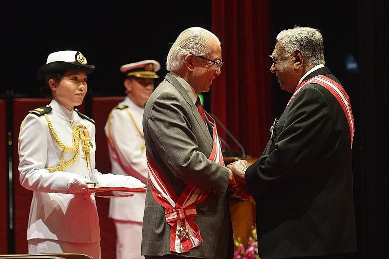 Mr Nathan receiving the Order of Temasek (First Class) from President Tan in 2013. As Prime Minister, Mr Lee has worked closely with two elected presidents, Mr Nathan and Dr Tan.