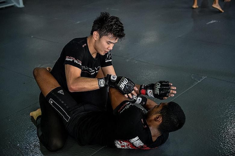 Benedict Ang training with Evolve MMA team-mate Amir Khan yesterday at Evolve Gym. They will feature at One Championship's Defending Honour event on Friday.