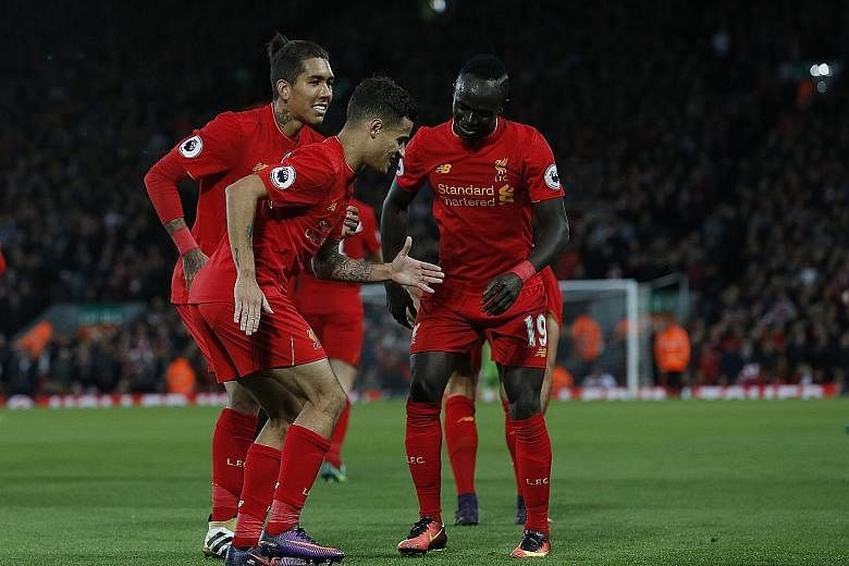 Liverpool's Philippe Coutinho (front) celebrates his goal with Roberto Firmino (left) and Sadio Mane during the Reds' 2-1 win against West Bromwich Albion. Mane also scored in the same Premier League game last month. The three forwards have accounted