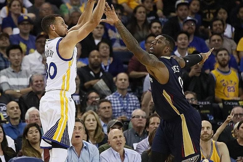 Warriors guard Stephen Curry shoots a three-pointer over Pelicans forward Terrence Jones in Golden State's 116-106 win at Oracle Arena. Curry had 46 points.