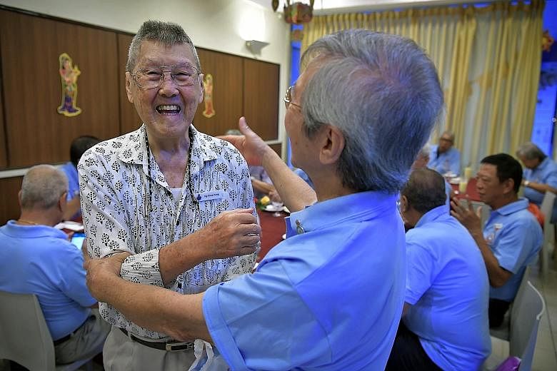 Mr Ng Chee Keng (left) being greeted by a fellow graduate of the Royal Air Force (Malaya) Training Centre. Many who attended the centre's first reunion yesterday have not seen one another in almost 50 years.