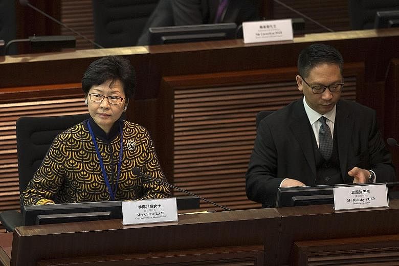 Mrs Lam and Mr Yuen being questioned at Hong Kong's Legco yesterday. Mr Yuen reiterated that Beijing has the right to interpret the Basic Law and this will not undermine Hong Kong's judicial system.
