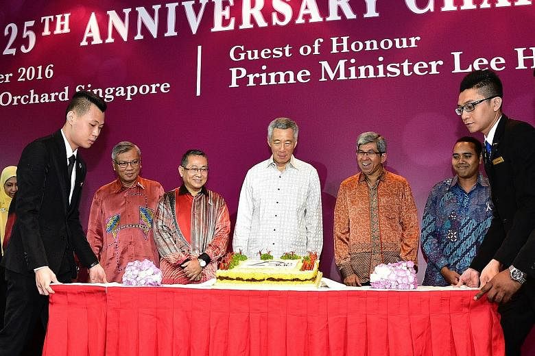 Celebrating the Association of Muslim Professionals' 25th anniversary yesterday were (from left) AMP executive director Mohd Anuar Yusop, AMP chairman Abdul Hamid Abdullah, PM Lee, Minister for Communications and Information and Minister-in- charge o