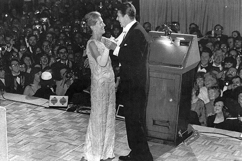 Mrs Nancy Reagan at the inaugural ball for her husband Ronald Reagan (both left), in a gown by James Galanos, in Washington in 1981.