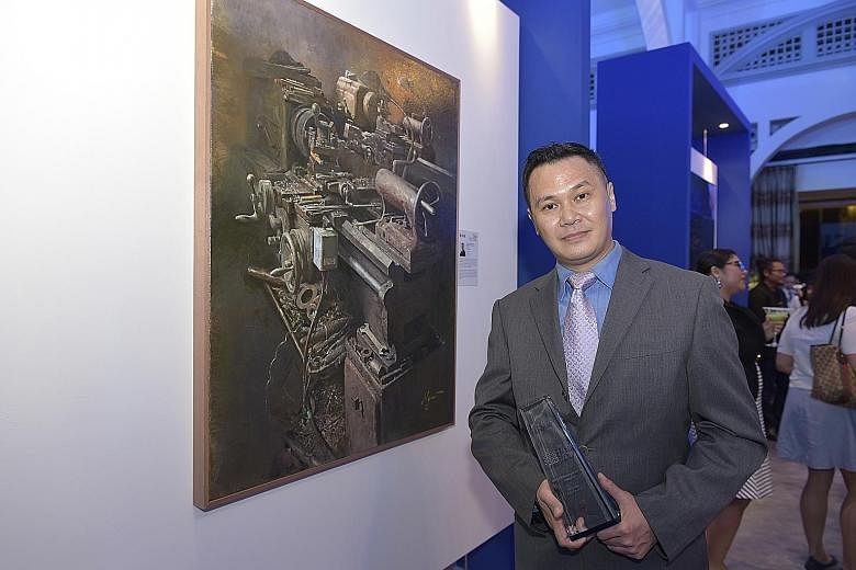 Mr Carey Ngai, winner of the UOB Painting of the Year Award (Singapore), with his piece Industry 2.0 III, which he said illustrates how the rise of artificial intelligence is rendering old machinery and older workers obsolete.