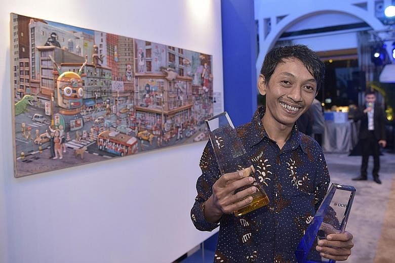 Jubilant Indonesian artist Gatot Indrajati after winning the 35th United Overseas Bank Painting of the Year (Indonesia) Award last night. He is also the third Indonesian in a row to win the UOB South-east Asian Painting of the Year Award, the first t