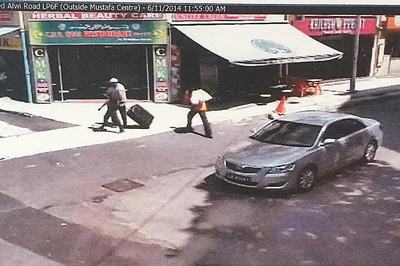 Left: An image from the Verdun-Syed Alwi junction. Ramzan said he was the one in black pulling the suitcase, while the man in white beside him was Rasheed. Right: An image from the Rowell-Kampong Kapor junction.